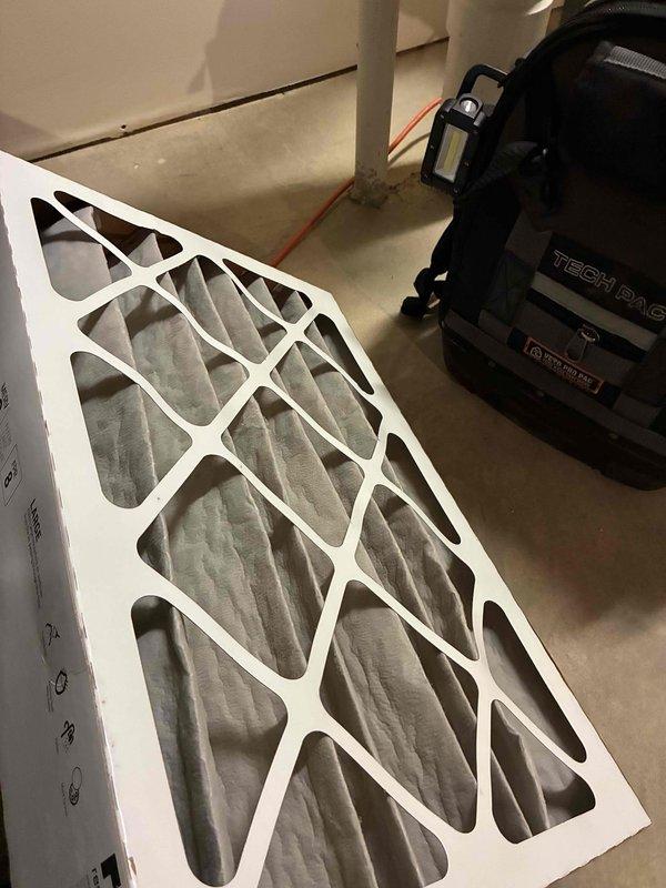 Performed scheduled furnace preventive maintenance under the recurring service agreement, including removal and cleaning of the flame sensor with an abrasive pad to eliminate oxidation buildup and restore reliable flame proving. Inspected and replaced the heavily dust-loaded return air filter to restore proper airflow, and evaluated thermostat operation in response to the customer's concern.