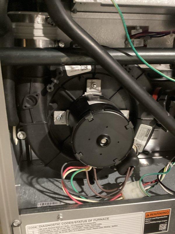 Responded to a no-heat call on a gas furnace presenting a flashing red LED fault code with a hot blower compartment. Removed the upper access panel and inspected the inducer motor and blower assembly, wiring harness and connections, gas valve, and flue/vent piping, then performed electrical diagnostics with a clamp meter and referenced the furnace diagnostic code chart to isolate the fault. No visible damage, corrosion, or wiring faults were observed, and the unit was left with the diagnostic findings documented.
