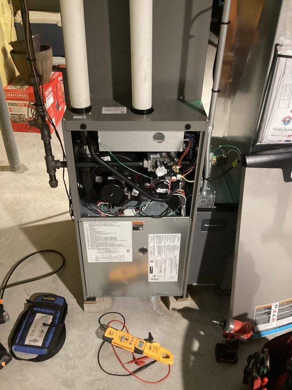 Responded to a no-heat call on a gas furnace presenting a flashing red LED fault code with a hot blower compartment. Removed the upper access panel and inspected the inducer motor and blower assembly, wiring harness and connections, gas valve, and flue/vent piping, then performed electrical diagnostics with a clamp meter and referenced the furnace diagnostic code chart to isolate the fault. No visible damage, corrosion, or wiring faults were observed, and the unit was left with the diagnostic findings documented.
