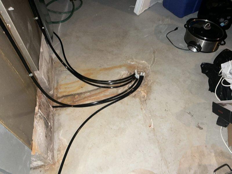 Performed a furnace replacement estimate after the heat exchanger failed, requiring the unit to be shut down for safety. Inspected the furnace and surrounding installation, noting heavy rust staining and concrete deterioration near the condensate/drain line termination point at the floor, indicating prolonged moisture exposure. Evaluated the system for replacement and documented conditions with photographs.