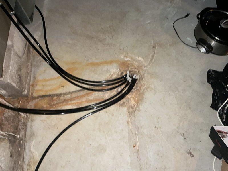 Performed a furnace replacement estimate after the heat exchanger failed, requiring the unit to be shut down for safety. Inspected the furnace and surrounding installation, noting heavy rust staining and concrete deterioration near the condensate/drain line termination point at the floor, indicating prolonged moisture exposure. Evaluated the system for replacement and documented conditions with photographs.