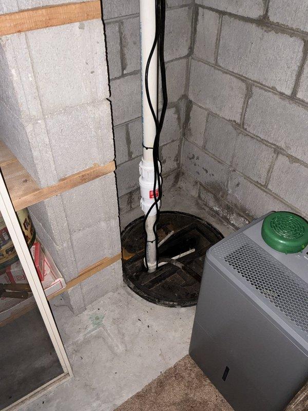 Performed a whole-home plumbing inspection, including the basement sump pit and discharge piping, which has a check valve and shows staining and moisture on the surrounding masonry walls and floor. Inspected the gas-fired water heater and found rust-colored staining and dampness on the floor at the base of the tank, indicating a possible leak or condensation issue that warrants further evaluation. Recommend monitoring the sump system and having the water heater connections and tank condition assessed for repair or replacement.