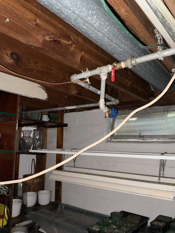 Performed an on-site estimate for replacement of existing lead water piping, inspecting the supply lines serving the laundry/utility sink and washing machine connections as well as the galvanized piping, valves, and copper lines run through the basement ceiling joists. Documented pipe conditions and routing with photos to determine the scope of work for replacing the lead piping with modern, code-compliant supply lines.