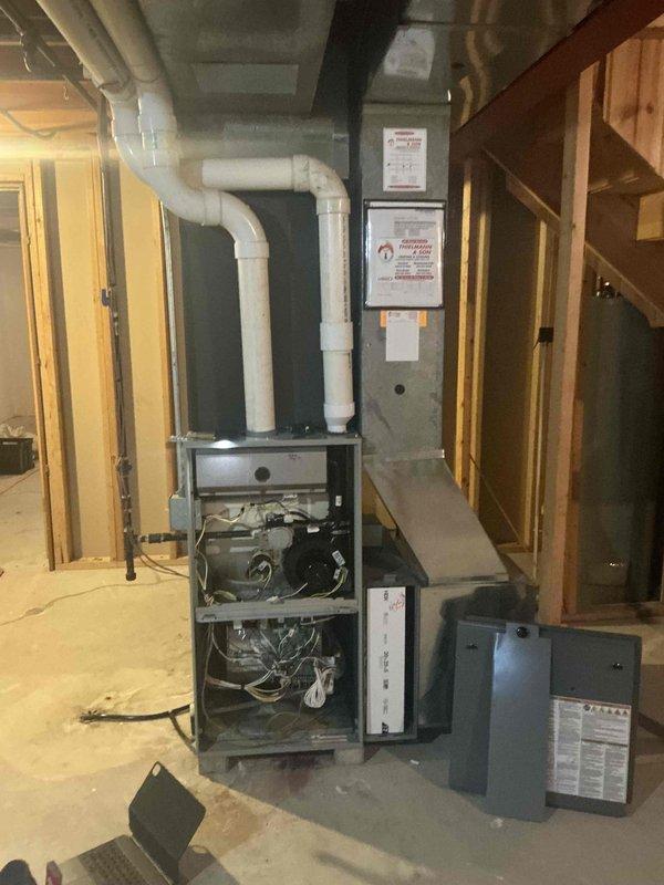 Performed an on-site evaluation of a 15-16 year old Trane gas furnace and found rust and corrosion inside the heat exchanger chambers, indicating the unit is nearing end of service life. Inspected the burner assembly, blower, control board, venting, ductwork, and condensate drain routing, documented conditions with photos, and provided a furnace replacement estimate.