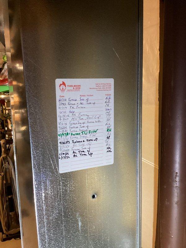 Performed a scheduled HVAC tune-up, inspecting the furnace, plenum, and supply ductwork, along with the flue connection to the water heater and surrounding condensate drain piping, with no evidence of rust, frost, or visible damage. Noted a small hole in the galvanized plenum that should be sealed, and updated the service log sticker on the duct with the completed tune-up entry.