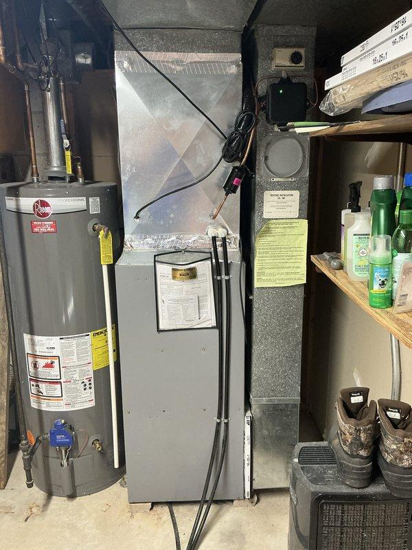 Performed an on-site evaluation for furnace replacement, inspecting the existing upright gas furnace and air handler with galvanized plenum, PVC venting, gas piping, and adjacent water heater, with no visible rust, frost, or damage noted. Documented equipment data plates and installation conditions, including the closet access and clearances, to support replacement scope and equipment sizing.
