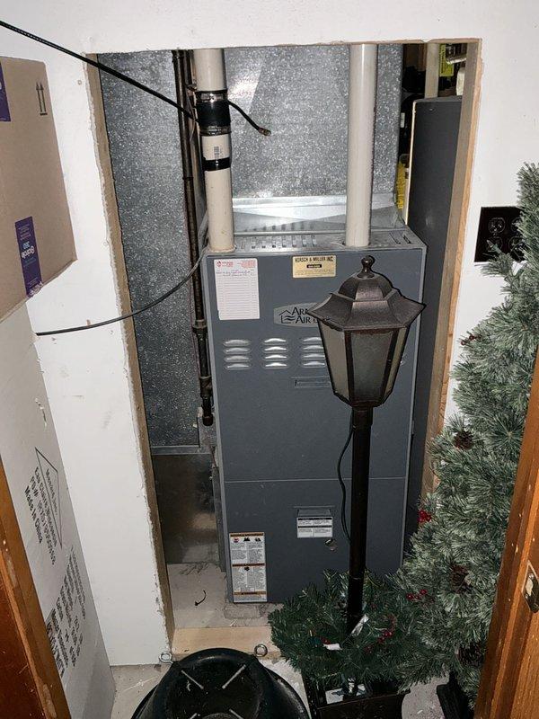 Performed an on-site evaluation for furnace replacement, inspecting the existing upright gas furnace and air handler with galvanized plenum, PVC venting, gas piping, and adjacent water heater, with no visible rust, frost, or damage noted. Documented equipment data plates and installation conditions, including the closet access and clearances, to support replacement scope and equipment sizing.