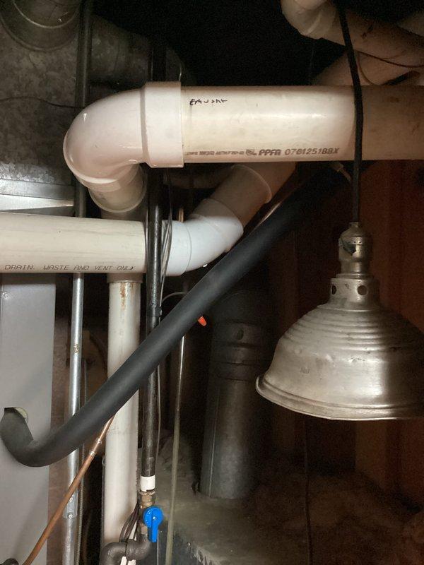 Performed a seasonal tune-up on a vertical gas furnace with an attached evaporator coil cabinet, inspecting the heat exchanger, draft inducer, pressure switch, blower motor, gas valve, and control wiring with the front panel removed. Verified condensate drain and PVC venting connections, checked the evaporator coil cabinet and associated components, and confirmed the Aprilaire air cleaner was in place. No frost, rust, or major damage observed, and the system was left in proper working order.