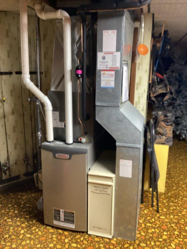 Responded to a service call for a leaking condensate pump on a gas-fired Lennox furnace with an attached Space-Gard air cleaner. Inspected the Little Giant condensate pump and associated discharge tubing and hose connections, identified the pump as the source of the leak, and quoted replacement of the unit. The furnace, PVC venting, and ductwork were inspected and found intact, with no visible rust, frost, or damage.
