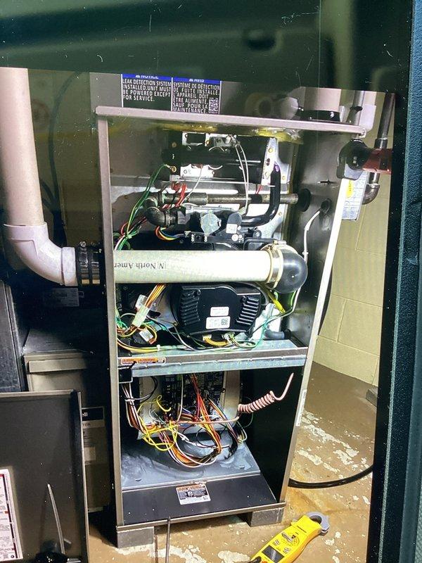 Responded to a no-heat call with a non-powering thermostat and inspected the furnace control board, low-voltage wiring, and terminal connections at the unit. Verified control voltage between R and C, checked for loose or improperly routed thermostat wiring, and tested with a clamp meter to isolate the cause of the power loss to the eco+ thermostat. Corrected the low-voltage wiring issue, restored power to the thermostat, and confirmed proper call for heat and normal furnace operation.