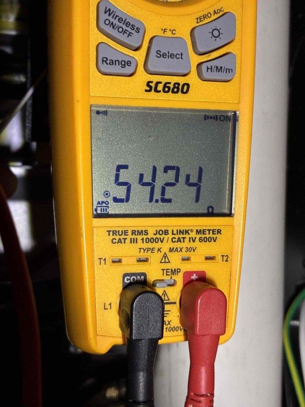 Performed a furnace tune-up, inspecting the air filter in its housing and finding it in serviceable condition with light, even loading and a minor exposed cardboard edge on the frame. Conducted electrical diagnostics with a true RMS clamp meter, measuring a resistance reading of 54.24 ohms to verify component integrity. The unit was left operating properly at completion of the service.