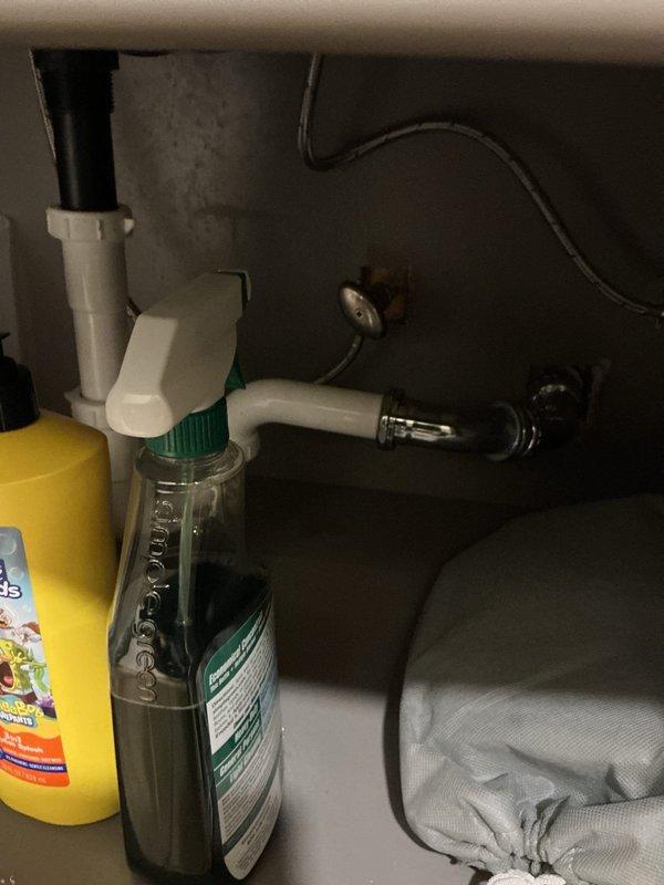 Installed a matte black two-handle, 8-inch widespread faucet with a matching pop-up drain assembly on the vanity's undermount sink, connecting the supply lines and drain and verifying proper flow and leak-free operation. Inspected the under-sink supply and shutoff valve connections, noting rust staining near the chrome supply fittings and valve, and checked the supply and drain connections for tightness. The jetted tub repair was identified as a separate item requiring further diagnosis.