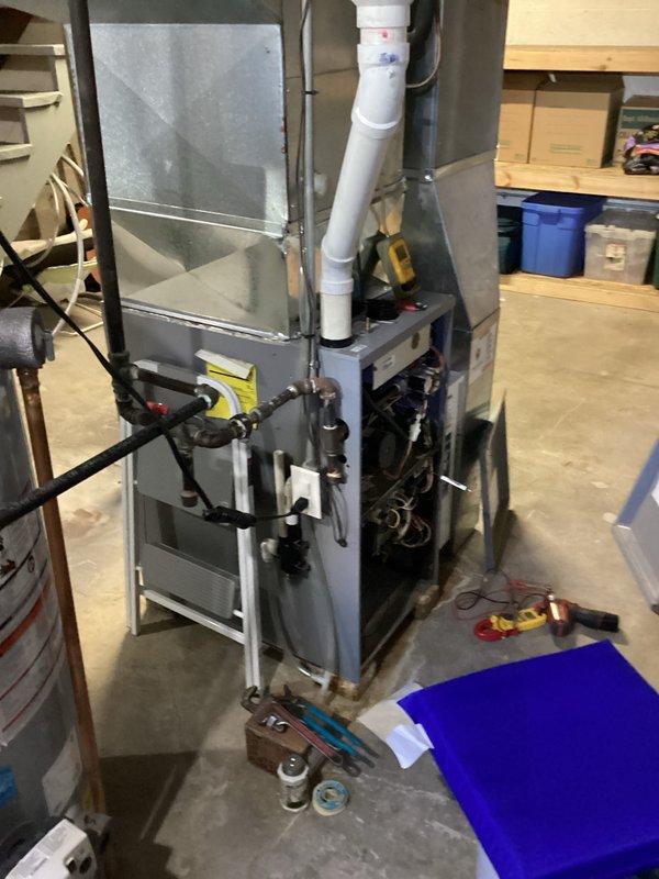 Responded to a no-heat call on a 15-year-old Armstrong A95UH2V furnace where the hot surface igniter would glow but gas never flowed and ignition did not occur. With the front access panel removed, inspected the gas valve assembly and associated wiring harness, and used a multimeter to test for voltage at the gas valve during the ignition sequence to verify valve operation and control signal. Completed diagnostics and service on the ignition and gas delivery components, restoring the furnace to normal operation.