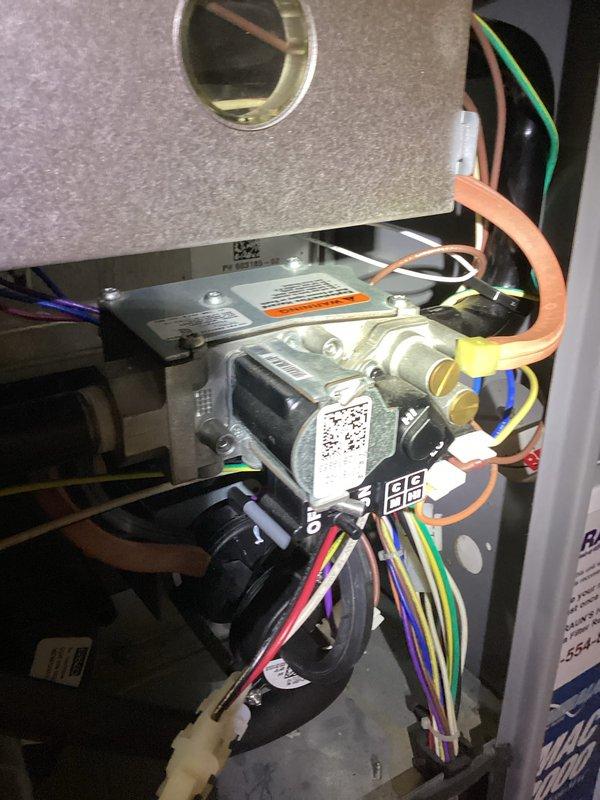 Responded to a no-heat call on a 15-year-old Armstrong A95UH2V furnace where the hot surface igniter would glow but gas never flowed and ignition did not occur. With the front access panel removed, inspected the gas valve assembly and associated wiring harness, and used a multimeter to test for voltage at the gas valve during the ignition sequence to verify valve operation and control signal. Completed diagnostics and service on the ignition and gas delivery components, restoring the furnace to normal operation.