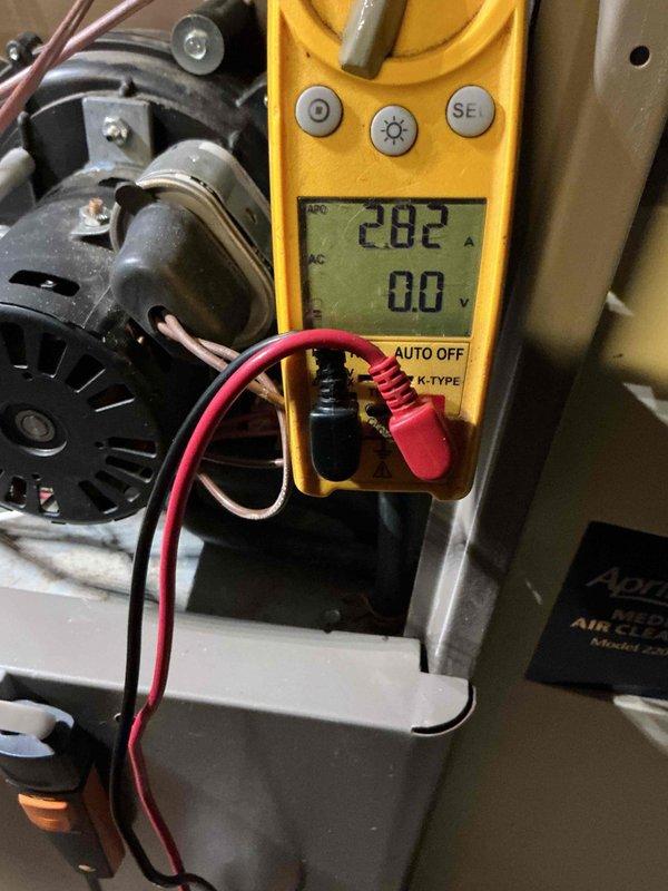 Performed HVAC tune-up, including electrical testing of the blower motor with a clamp meter, which measured 2.82 A running amperage. Inspected the interior of the system with a borescope camera and evaluated the Aprilaire media air cleaner cabinet and surrounding components, noting dust and grime buildup on the motor and adjacent metal surfaces.