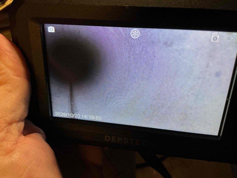 Performed HVAC tune-up, including electrical testing of the blower motor with a clamp meter, which measured 2.82 A running amperage. Inspected the interior of the system with a borescope camera and evaluated the Aprilaire media air cleaner cabinet and surrounding components, noting dust and grime buildup on the motor and adjacent metal surfaces.