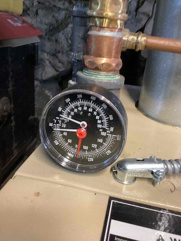 Performed annual tune-up on gas-fired boiler, inspecting the temperature/pressure gauge, expansion tank, and associated copper and brass piping and fittings, with no leaks, corrosion, or damage observed. Verified the flue venting to the chimney and flexible electrical conduit connections were secure and in good condition, and confirmed the unit was operating normally at completion.