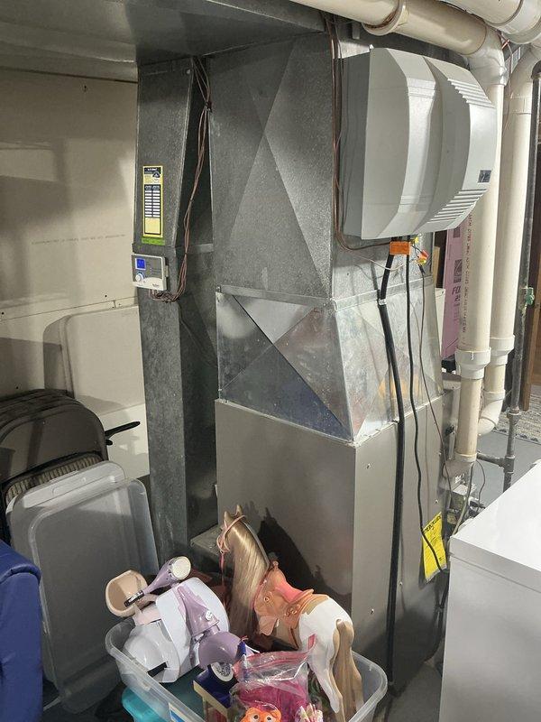 Performed an on-site estimate for replacement of a 17-year-old Lennox natural gas furnace located in the basement mechanical area, following a recommendation from a prior maintenance visit. Inspected the existing furnace, galvanized plenum and ductwork, whole-house humidifier, and associated PVC piping, documenting equipment condition and layout with photos to support replacement options. The unit and surrounding components showed no visible rust, frost, or major damage, and the work area was assessed for access and installation requirements.