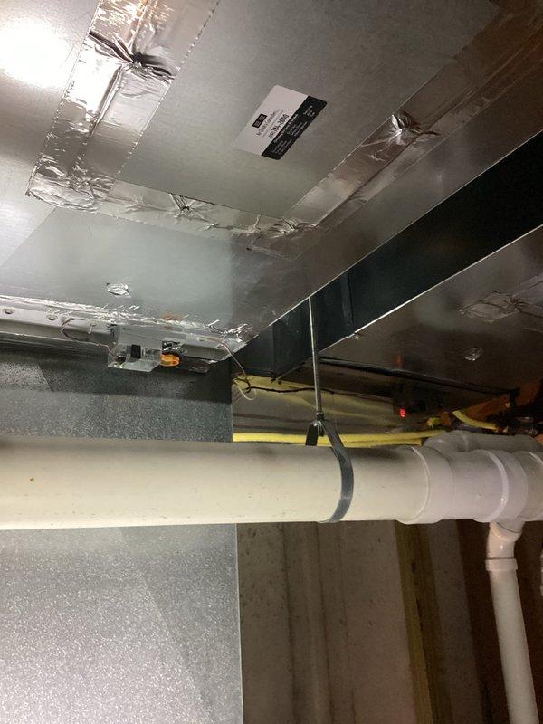 Inspected the Lennox gas furnace and associated supply ductwork in response to reduced airflow at two rooms, verifying sealed duct seams, PVC venting and condensate piping, and gas line connections with no visible damage or obstruction. Noted standing water on the basement floor near the furnace, and recommend further evaluation of the condensate drain and airflow balancing to restore adequate delivery to the affected rooms.