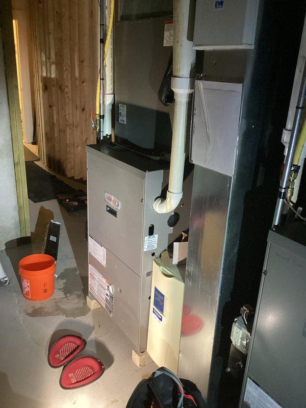 Inspected the Lennox gas furnace and associated supply ductwork in response to reduced airflow at two rooms, verifying sealed duct seams, PVC venting and condensate piping, and gas line connections with no visible damage or obstruction. Noted standing water on the basement floor near the furnace, and recommend further evaluation of the condensate drain and airflow balancing to restore adequate delivery to the affected rooms.
