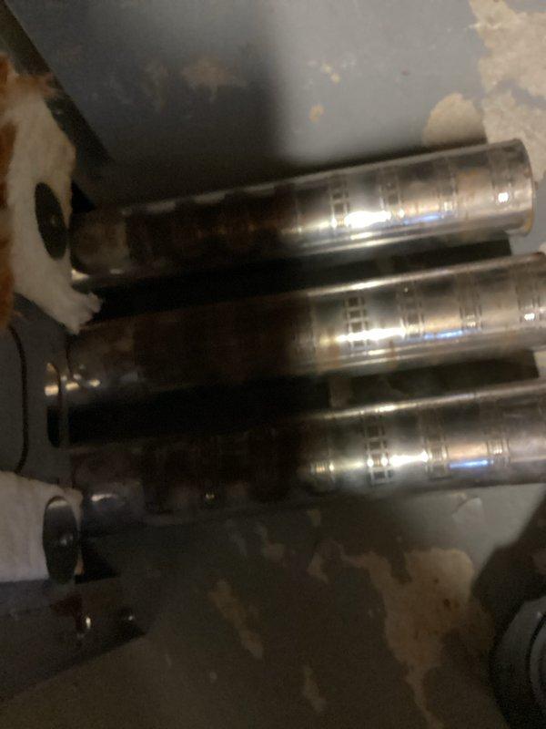 Performed a tune-up on a Lennox high-efficiency boiler, including removal of the front access panel to inspect the interior components, flue piping, and associated copper piping, valves, and pressure gauge. Documented corrosion and discoloration on the stainless steel components, and reinstalled the access panel upon completion.