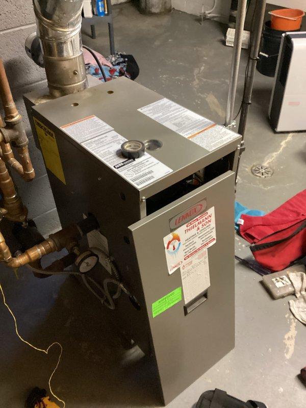 Performed a tune-up on a Lennox high-efficiency boiler, including removal of the front access panel to inspect the interior components, flue piping, and associated copper piping, valves, and pressure gauge. Documented corrosion and discoloration on the stainless steel components, and reinstalled the access panel upon completion.