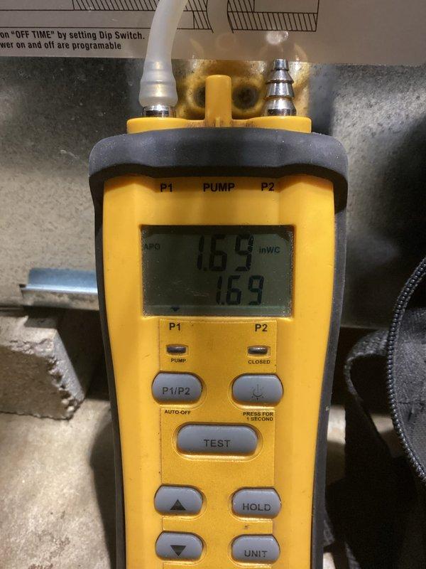 Performed a tune-up on the HVAC system, including a static pressure check with a digital manometer, which measured 1.69 inWC. Inspected the condensate drain piping, refrigerant line set, and plenum connections, and found no visible leaks, rust, ice, or damage. Verified system documentation and warranty paperwork were on file at the equipment.