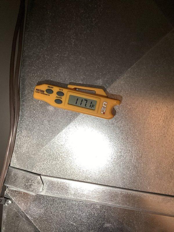 Performed a prepaid seasonal furnace tune-up, inspecting the blower assembly, condensate drain tubing and PVC fittings, wiring, and cabinet interior for wear or corrosion. Measured supply air temperature at the ductwork with a digital probe thermometer (117.1°F) to verify proper heating operation, and noted minor corrosion on a wire clip for monitoring.