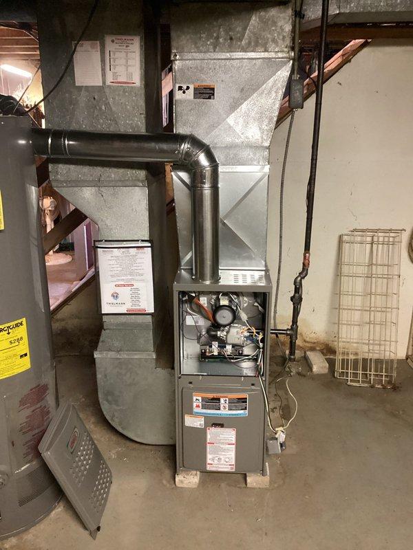 Installed a new 80% AFUE gas furnace, connecting the supply plenum and ductwork, venting the flue through a sealed round vent connector with an elbow, and the gas supply with a shutoff valve. Reused the existing filter and thermostat, and completed the electrical connections under permit with a licensed electrician. Verified safe ignition, proper burner operation, and airflow before returning the system to service.