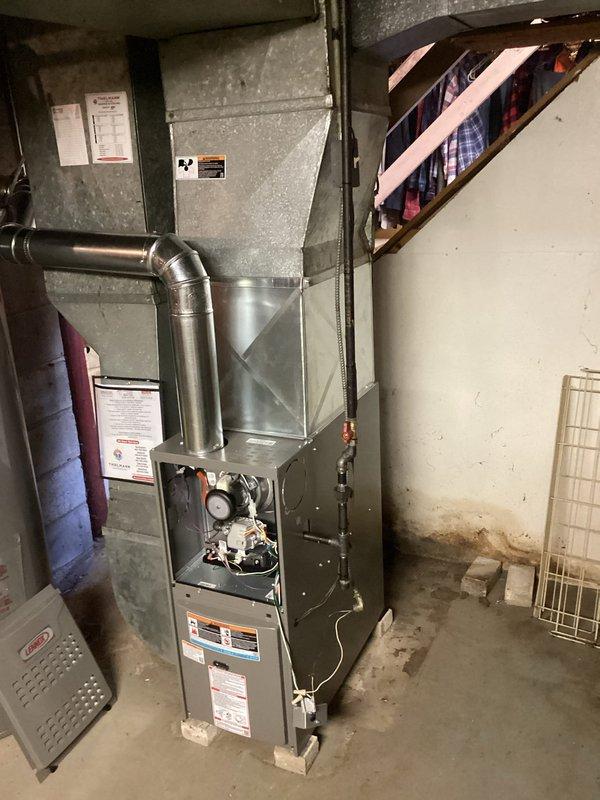 Installed a new 80% AFUE gas furnace, connecting the supply plenum and ductwork, venting the flue through a sealed round vent connector with an elbow, and the gas supply with a shutoff valve. Reused the existing filter and thermostat, and completed the electrical connections under permit with a licensed electrician. Verified safe ignition, proper burner operation, and airflow before returning the system to service.