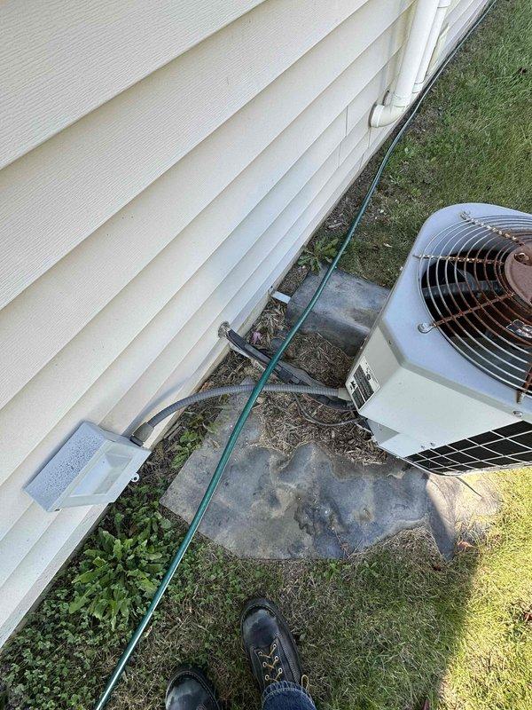 Performed an on-site estimate for replacement of the furnace and air conditioning system; the existing 24-year-old equipment is operational but at the end of its expected service life. Inspected the outdoor condenser, which shows heavy corrosion on the fan guard and fan hub, a weathered and uneven mounting pad, and debris accumulation around the unit, and evaluated the Carrier gas furnace, ductwork, and surrounding utility space for replacement equipment sizing and installation requirements. Documented equipment conditions with photographs, including the electrical disconnect, flexible conduit connection, and unit data plate, in preparation for system replacement recommendations.