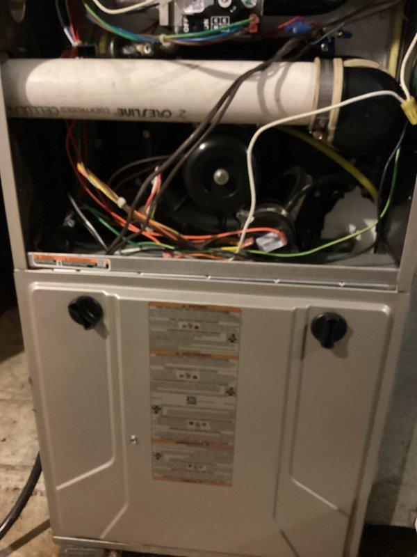 Responded to a no-heat call on a 15-year-old gas furnace displaying a solid yellow status LED with a 2-long, 3-short flash code, which indicates a pressure switch fault (open pressure switch with the inducer running). Removed the upper access panel and inspected the draft inducer assembly, PVC vent piping, rubber coupler, and pressure switch tubing for obstructions, restrictions, or leaks, then verified proper operation and restored the unit to service.