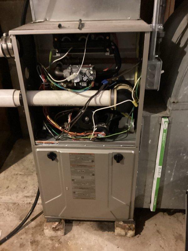 Responded to a no-heat call on a 15-year-old gas furnace displaying a solid yellow status LED with a 2-long, 3-short flash code, which indicates a pressure switch fault (open pressure switch with the inducer running). Removed the upper access panel and inspected the draft inducer assembly, PVC vent piping, rubber coupler, and pressure switch tubing for obstructions, restrictions, or leaks, then verified proper operation and restored the unit to service.