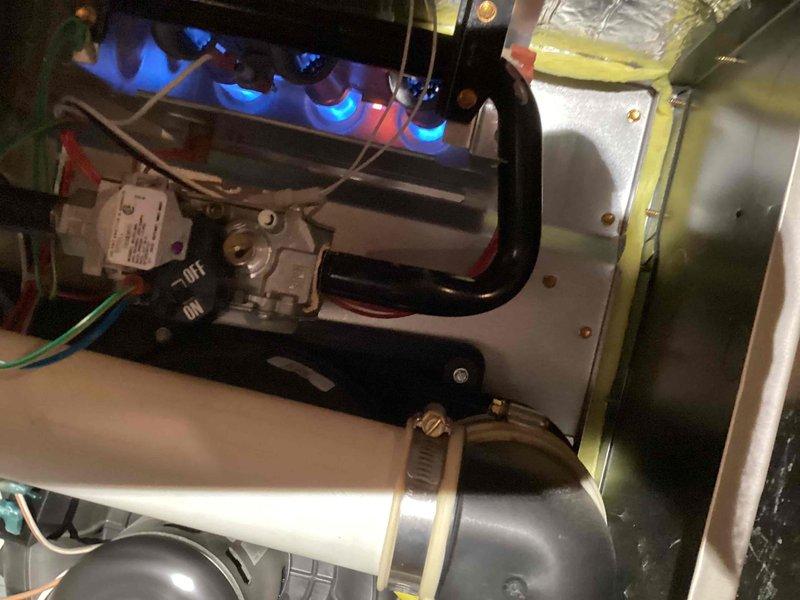 Performed a complete furnace tune-up, inspecting the burner assembly, gas valve, igniter/flame sensor, inducer motor, wiring, and condensate drain connections. Burners displayed active flame with proper ignition, and no signs of rust, cracking, or frost were found; the system was verified to be operating normally.