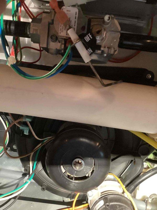 Performed a complete furnace tune-up, inspecting the burner assembly, gas valve, igniter/flame sensor, inducer motor, wiring, and condensate drain connections. Burners displayed active flame with proper ignition, and no signs of rust, cracking, or frost were found; the system was verified to be operating normally.