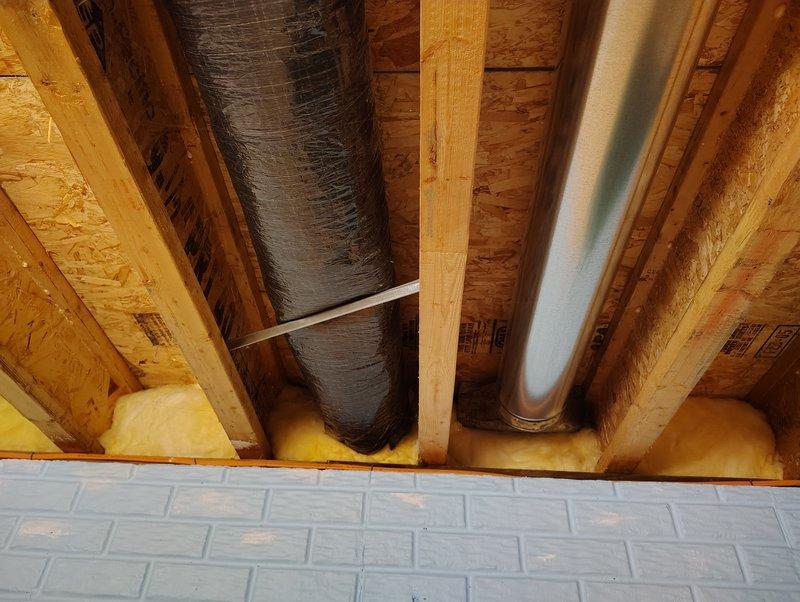 Inspected the exterior wall vent serving the customer's Broan-NuTone ventilation system and found the plastic cover severely cracked and broken, with the wire grille exposed and heavily coated in dirt and debris. Verified the associated flexible and rigid galvanized ductwork in the joist bays and found no significant damage, then evaluated replacement options for the 8"x8" opening to restore proper exterior exhaust termination.