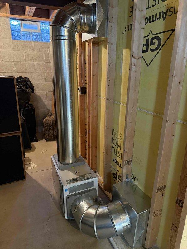 Installed a new furnace and air conditioning condenser as a complete system replacement, with the electrical work and permits handled for the installation. The refrigerant circuit was evacuated with a digital manifold gauge to a deep vacuum of 387 microns to verify it was leak-free and moisture-free before startup. The furnace was set in the basement with new galvanized supply and return ductwork connected to the plenum, and the equipment and ductwork showed no signs of damage, frost, or corrosion.