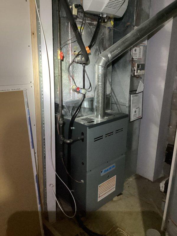 Responded to a no-heat-delivery complaint on a Daikin gas furnace, with the heating cycle initiating but minimal airflow reaching the conditioned space. Inspection revealed a severely clogged return air filter, heavily loaded with dust and debris, restricting airflow across the heat exchanger. The restricted filter was removed and replaced to restore proper airflow, and the system was verified for normal heating operation and adequate airflow at the registers.