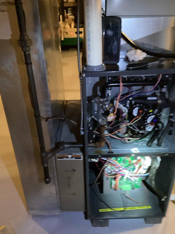 Performed a furnace tune-up with access panels removed, inspecting the gas valve, inducer/blower assembly, control board, wiring harnesses, and gas piping connections. Inspected and serviced the flame sensor/igniter assembly, verified secure electrical connections, and checked the PVC vent and ductwork, noting no visible rust, frost, or damage.