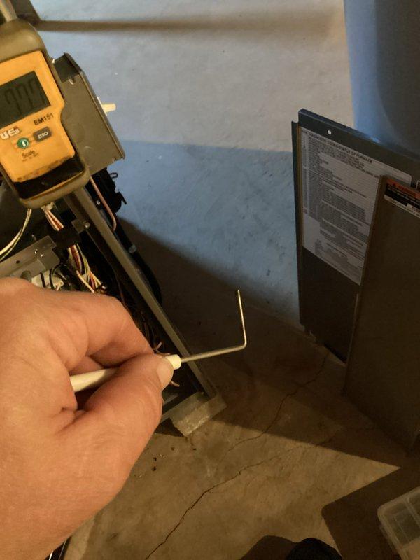 Performed a furnace tune-up with access panels removed to inspect the burner assembly, gas valve, inducer motor, control board, and wiring harness. Verified gas manifold pressure using a digital manometer and tested electrical components with a multimeter to confirm proper operation. Documented the furnace's internal condition, including loose and unsecured wiring in the control compartment.