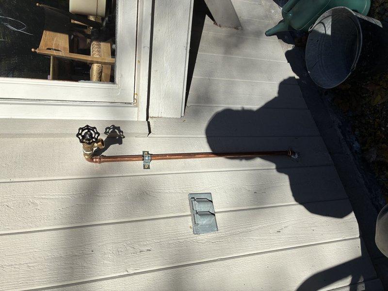 Installed a new exterior hose bibb and ran copper supply piping from the existing line through the crawlspace cavity to the exterior wall, using soldered joints, a branch tee with an isolation valve, and a securely clamped horizontal run. Insulated the supply piping within the wall cavity to protect against freezing and confirmed the new hose bibb is properly mounted and operating with no leaks.