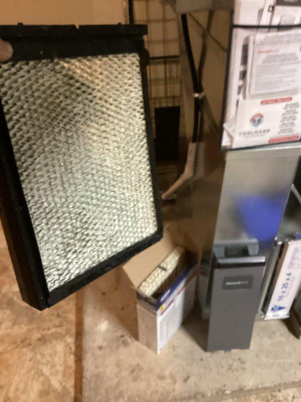 Performed a seasonal tune-up on the furnace and humidifier system, inspecting the cabinet, wiring, and flame sensing components for proper operation. Found the humidifier water panel pad heavily scaled with mineral buildup and replaced it with a new pad to restore proper humidification performance. Verified the 15x25x4 media filter fit and system operation, with no visible damage, rust, or frost noted.