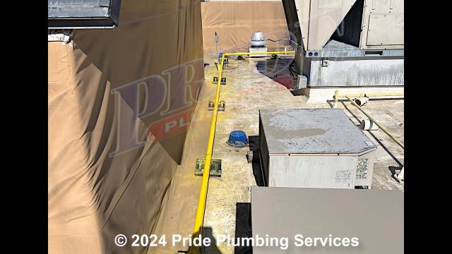 Pride Plumbing came out and installed black iron piping on the roof for gas lines, installed drip legs and shutoff valves, ran the piping down the side of the building, connected it to five propane canopy heaters, and painted the piping yellow.