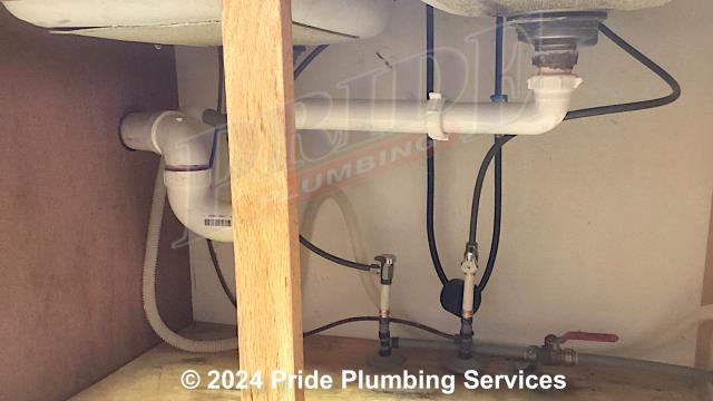 Pride Plumbing came out and replaced a centerset kitchen sink faucet with a new customer supplied centerset model. This included removing the old faucet, mounting the new faucet, and replacing the hot and cold above-floor water supply lines underneath the sink with new braided stainless steel ones. We also replaced the old faucet's hot and cold ball shutoff valves with new water supply stops - one with an angle stop and the other with a straight stop.