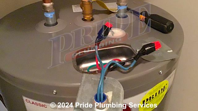 Pride Plumbing was called out for a Rheem water heater not heating the water. We tested the power going to the unit and found that it wasn't getting any. Our inspection found that the neutral wire had came out of its wire nut. We cut the power off, reattached the wire inside the wire nut, and put electrical tape around it to prevent it from coming out again. Once we cut the power back on, the unit began heating the water again.