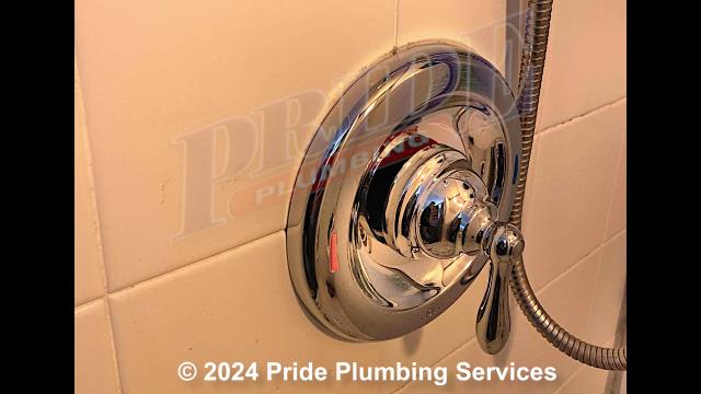 Pride Plumbing came out, and after cutting an access in the wall, replaced a leaking bathtub/shower faucet valve with a new customer-supplied Moen rough-in valve; added a chrome trim kit (replacing the shower head, handheld wand, valve cover, and handle); converted the valve's copper above-floor hot and cold water supply lines to PEX piping and fittings - tying them into the home's existing copper main water lines; and installed a plastic plumbing access panel over the hole we cut in the wall.
