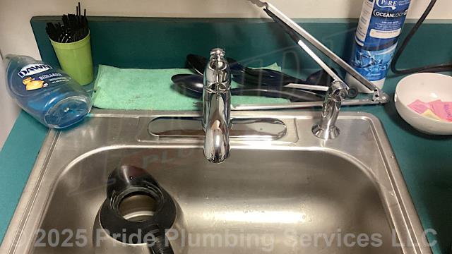 Pride Plumbing was called out for a broken plastic trip lever on a toilet in the scale house and a leaking single-handle centerset kitchen sink faucet in a breakroom. For the toilet, we replaced the plastic trip lever with a new metal one because the customer stated that the plastic ones keep breaking. For the kitchen sink faucet, we replaced it with a new customer-supplied single-handle centerset model with a sprayer. This included removing the old faucet, mounting the new faucet, connecting the sprayer, and replacing the hot and cold above-floor water supply lines underneath the sink with new braided stainless-steel ones.