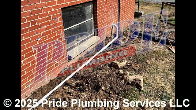 Pride Plumbing came out and performed the following work: 1) dug down and uncovered an existing gutter drain to gain access to the pipe; 2) installed a new 2-inch PVC discharge line underground over the gutter drain; 3) connected the new gutter drain underground and to an existing pump system; 4) turned on the pump and checked for leaks and working order; and 5) covered the area that we dug up and spread grass seed and straw.