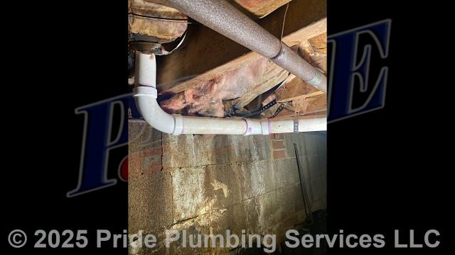Pride Plumbing came out and replaced a kitchen sink's under-sink drain assembly, P-trap, and cast iron drain line through the floor to under the house in the crawlspace, and to where it ties into the main sewer drain stack, with new PVC piping and fittings, tying back onto the existing cast iron drain line with a new Fernco coupling. Also, underneath the sink, we added a cleanout and an air admittance valve to the new drain line and capped off the old cast iron drain line coming in through the wall.