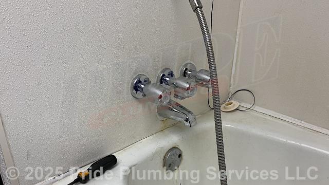 Pride Plumbing came out and replaced a leaking three-handle bathtub/shower valve with a new Gerber G004803083 three-handle model (this included cutting an access in the shower wall, replacing the valve along with short sections of its hot- and cold-water supply lines with new PEX piping and fittings, adding new stems, washers, seats, handles, and escutcheons, installing the shower head, downspout diverter, and a plastic plumbing access panel over the access hole we cut in the wall).